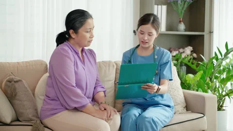 Doctor is asking about the illness of an elderly person in a nursing home. Stock Footage 247413646