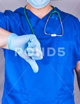 Doctor in blue uniform and latex sterile gloves shows a gesture is bad Stock Photos