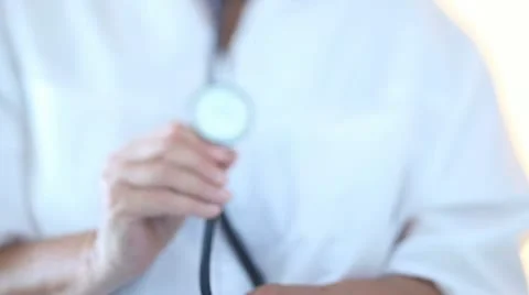 Doctor bringing forward a stethoscope Vidéo 11424479