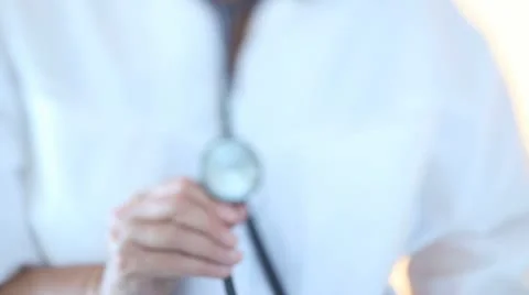 Doctor bringing forward a stethoscope Stock Footage 11424485