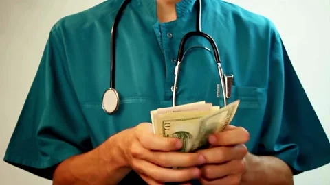 Doctor with a bundle of dollar banknotes. Hands of a doctor counting dollar Stock-Footage 336264477
