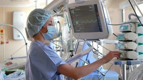 Doctor changes data on the monitor's screen in intensive care unit Stock Footage 72648399