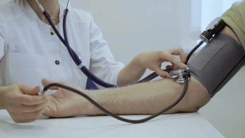 Doctor check pulse with tonometer and stethoscope Stock Footage