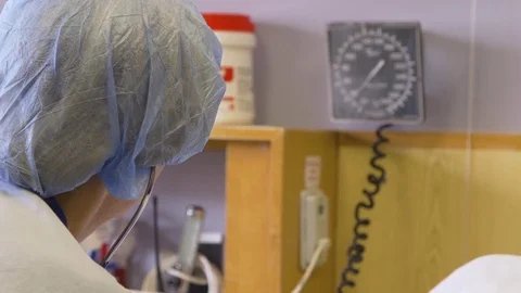 Doctor checking blood pressure gauge for a patient Stock Footage 85179556