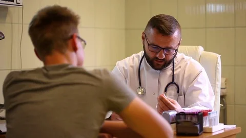 Doctor checking blood sample and telling good news to the patient Stock Footage 77885862