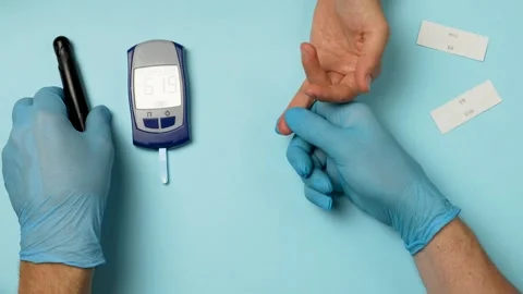 Doctor checking blood sugar level with glucometer. Stock Footage 254011132