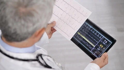 Doctor checking ecg data on tablet Stock Footage 123226243