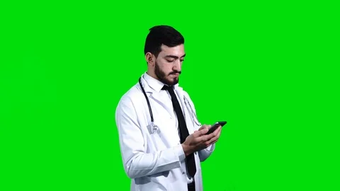 Doctor checking his phone with one finger. Stock Footage 92336688