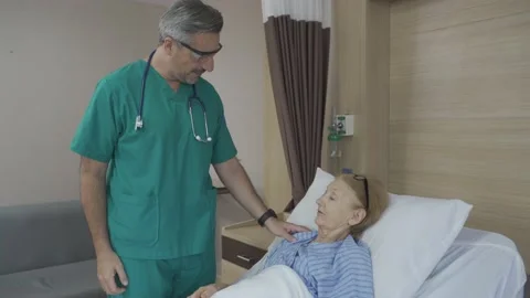 Doctor checking old lady patient's pulse Stock Footage 156683644