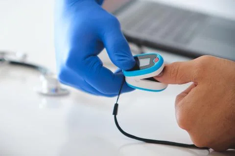 Doctor checking patient oxygen level with pulse oximeter Stock Photos