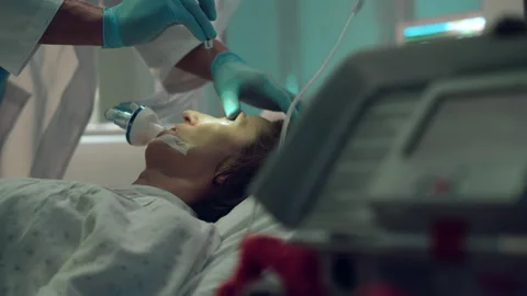 Doctor checking patient oxygen mask with flashlight test in intensive care unit. Stock Footage 179926016