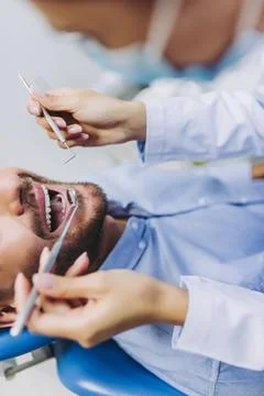 Doctor checking patient teeth Stock Photos