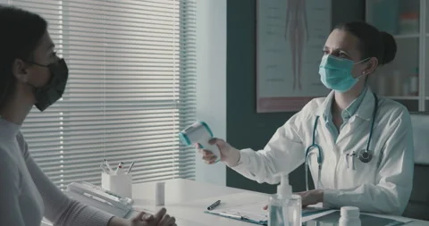 Doctor checking a patient's body temperature Stock Footage 151232168