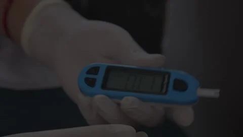 Doctor checking patient's diabetes level with glucose meter Stock Footage 241800906