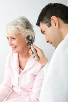 Doctor Checking Patient's Ear Using Otoscope Stock Photos