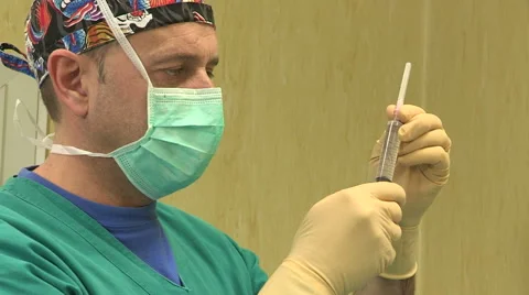 Doctor checking syringe Stock Footage 45899010