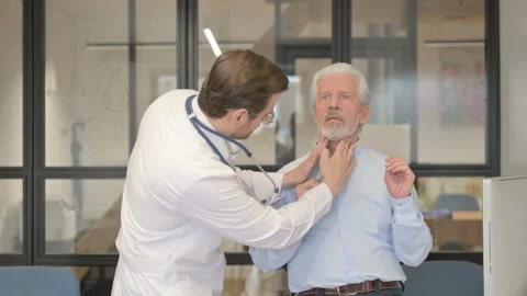 Doctor Checking Tonsils of Old Patient in Clinic Stock Footage 253513629