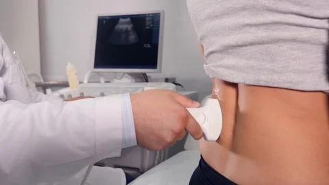 The doctor checks the patient's back, spine with an ultrasound Stock Footage