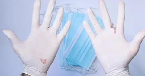 Doctor, client showing poor quality medical, protective glove Stock Footage 133647528