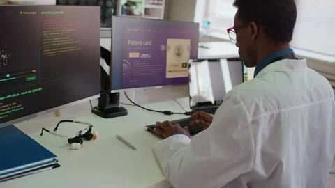 Doctor Coding on Computer with High Tech Software during Research in Laboratory Stock Footage 332359364