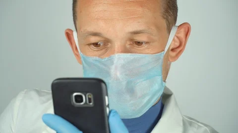 Doctor communicates through video communication of mobile smartphone. Video stock 128960229