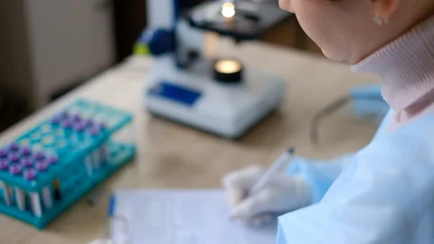 The doctor conducts research in the laboratory. Writes information. Stock Footage