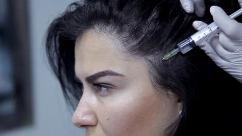 The doctor-cosmetologist performs the procedure of mesotherapy, injections into Stock Footage 81109088