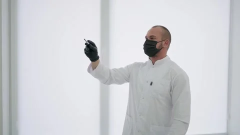 The doctor creates an appointment schedule on the electronic board Stock Footage 248642755