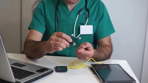 Doctor Demonstrating Finger Prick Test for Diabetes Monitoring Stock Footage 333079329