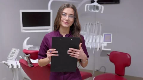 Doctor dentist working in office, using clipboard and making notes Stock Footage 239417916