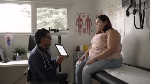 Doctor with digital tablet discussing test results with patient Stock Footage 221033418