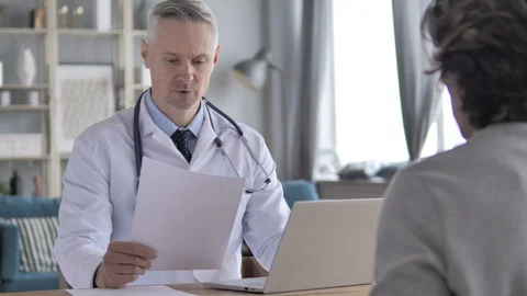 Doctor Discussing Treatment with Patient and Giving Perscription Stock Footage