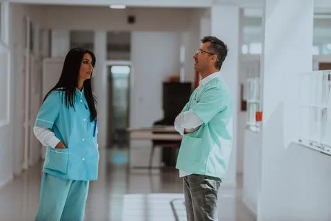 A doctor in a discussion with a nurse about Stock Photos