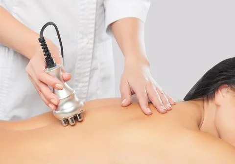 The doctor does the Rf lifting procedure on the back of a woman in a beauty p Stock Photos