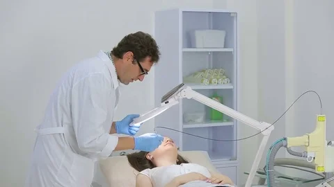Doctor doing laser operation for removing papilomas Stock Footage 73772207