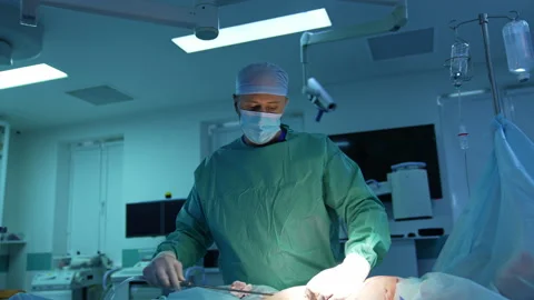 Doctor doing liposuction in operating room. Video stock 158367280