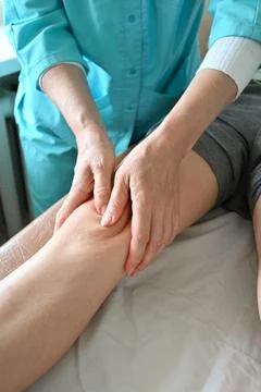 Doctor doing massage Stock Photos
