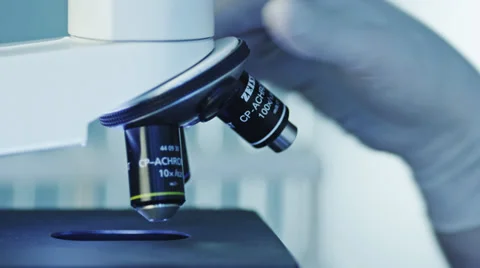Doctor Doing Research, using a Microscope Stock Footage 37009653