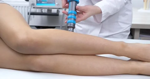 The Doctor doing Shock Wave therapy on Feet for a Sport Fit Girl in Modern Stock Footage 134158531