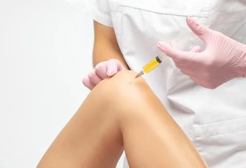 Doctor doing stem cell therapy on a patient's knee after the injury. Treating Stock Photos