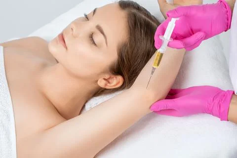 Doctor doing stem cell therapy on a patient's elbow after the injury. Treatin Stock Photos