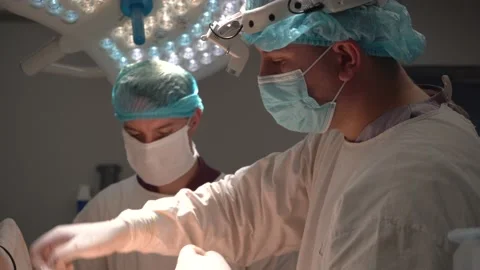 Doctor doing surgery in modern operating room Stock Footage 194357628