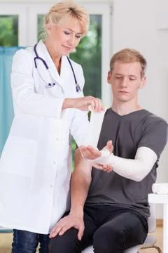 Doctor dressing upper limb Stock Photos