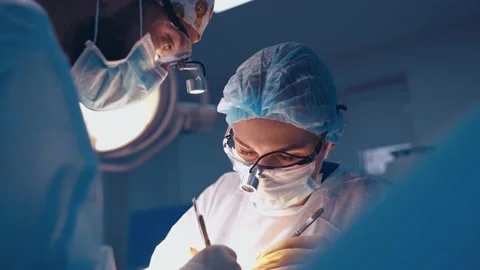 Doctor during surgery in operating room Stock Footage 133033197