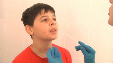 Doctor examines the boy his throat 2 Stock Footage