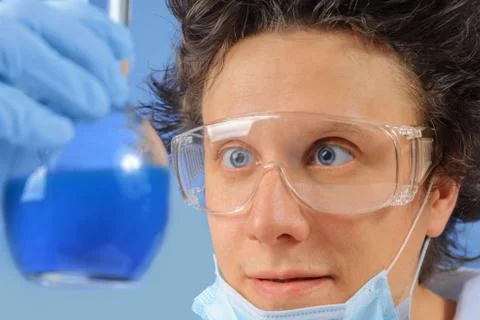 Doctor examines flask Stock Photos