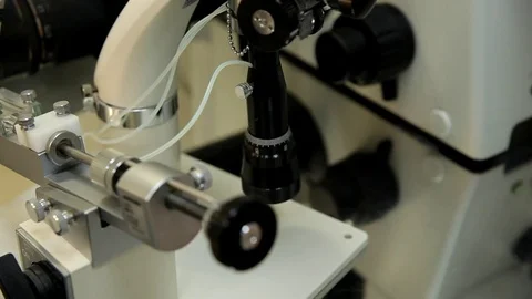 The doctor examines the sperm samples under a microscope. Stock Footage 76365260