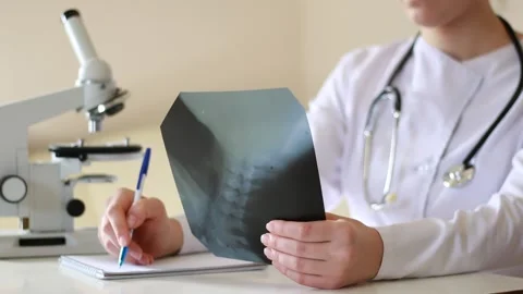 Doctor examines X-rays of the cervical vertebrae Stock Footage 143120167