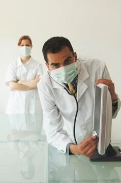 Doctor examining computer screen Stock Photos