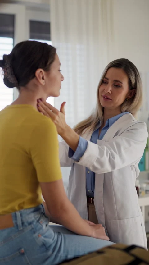 Doctor examining lymp nodes on neck of the teenage girl. Palpation of lymph Stock Footage 259898361